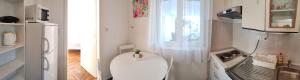 a small kitchen with a white toilet in a room at Apartmani Bojana in Rovinj +8 photos