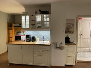 a kitchen with a sink and a microwave at Juifen in Lenggries
