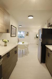 a kitchen with a refrigerator and a table in it at Apt 5 Miami Designer Apartment in the Upper East-Side in Miami