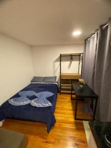 a bedroom with a bed and a table in it at Cabanas Loft Paraíso in Gramado