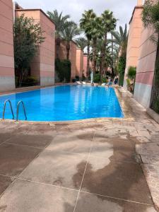 a large blue swimming pool in a building at Riad le pélican in Marrakech