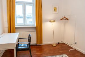 a room with a table and a lamp and a window at Mokotowska 7 in Warsaw +4 photos