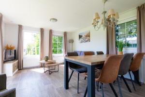 a dining room with a table and chairs at Chalet Plantlust in Veere