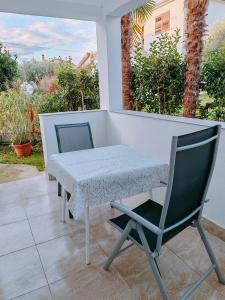 a table and two chairs on a patio at Studio Bobo in Rovinj