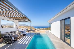 a villa with a swimming pool with a view of the ocean at Villa Pleiades in Karpathos