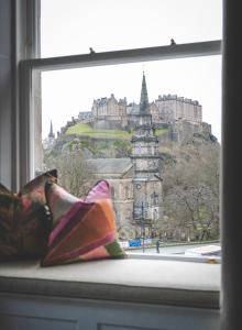 a window with a view of a castle at The Rutland Hotel & Apartments in Edinburgh