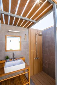 a bathroom with a sink and a shower at Villa Pleiades in Karpathos