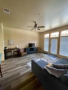 a living room with a couch and a ceiling fan at Cannery Square Apartment 104 in Sun Prairie