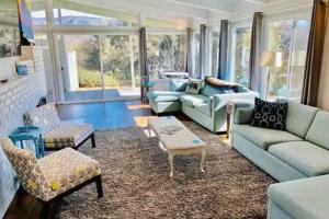 a living room with couches and chairs and a table at Black Bear Haven Hot tub Pool table BBQ Darts in Oakhurst +33 photos