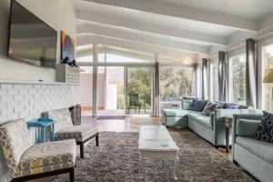 a living room with a couch and a table at Black Bear Haven Hot tub Pool table BBQ Darts in Oakhurst