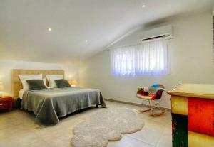 a bedroom with a bed and a window and a rug at Villa terranga in Calenzana