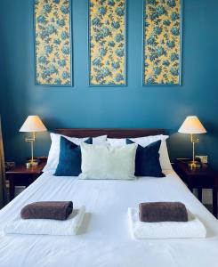 a bedroom with a white bed with two towels on it at Weston Hotel in Scarborough