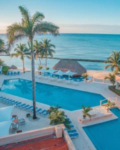 an aerial view of a resort with a pool and the ocean at Rincón Natural PA in Puerto Aventuras