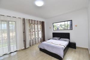 מיטה או מיטות בחדר ב-Kigali stay