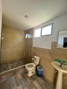 a bathroom with a toilet and a sink at Hotel Villa Maria Uribia in Uribia