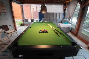 a pool table with cue balls on top of it at Domki Akwen in Rewal