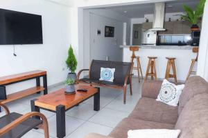 a living room with a couch and a table at Apartamento D&D Huanchaco in Huanchaco