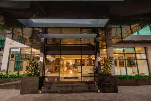 a building with glass doors and stairs in front at The Safron Hotel in Lagos