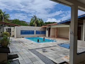 two people in a swimming pool in a house at Sonho dos golfinhos in Recife