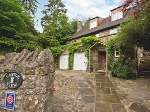 a stone house with a gate and a garage at Castle View in Richmond
