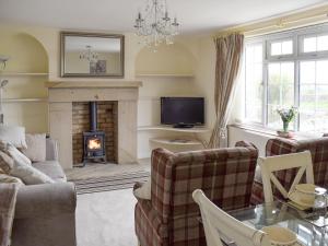 a living room with a couch and a fireplace at Rudda Farm Cottage - Uk2492 in Staintondale