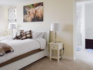a bedroom with a bed with a picture of a bull at Rudda Farm Cottage - Uk2492 in Staintondale