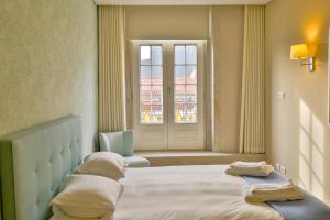 a bedroom with a large bed and a window at Cardosas Square Luxury Apartments by Porto City Hosts in Porto