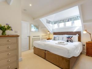 a bedroom with a large bed and a window at The Old Estate Office - Uk46358 in Grantley
