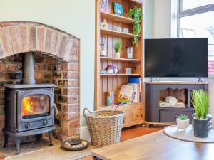 a living room with a fireplace and a stove at 25 Appledore Gardens in Chester-le-Street