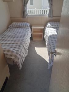 two beds sitting next to each other in a room at Camber Vacations in Camber