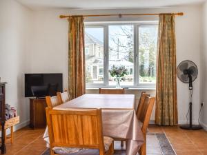 a dining room with a table and a window at The Stables in Ely