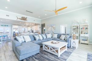 a living room with a blue couch and a table at Waves of Grace in Dauphin Island