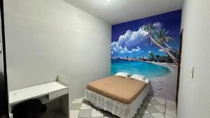 a bedroom with a beach mural on the wall at Casa Piauí Hostel in Teresina