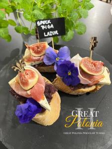 a group of sandwiches with meat and flowers on them at Great Polonia Wrocław Tumski in Wrocław