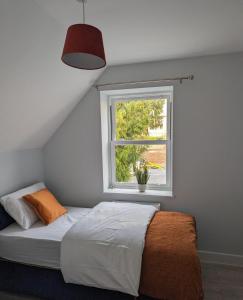 a bedroom with a bed and a window at Dover luxury apartments, near Ferry in Dover