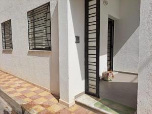 an open door of a building with a window at Dar Saloua in Nabeul