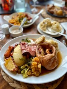 a plate of food with onion rings and other foods at Weston Hotel in Scarborough