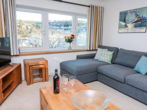 a living room with a couch and a table with wine glasses at Leeward in Dartmouth