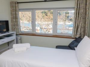 a bedroom with a large bed and a window at Leeward in Dartmouth
