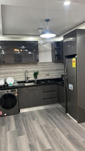 a kitchen with a stainless steel refrigerator and a dishwasher at NBA PLUSH APARTMENT - NSROMA in Accra