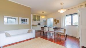 a living room with a white couch and a table at Fabulous Boavista Apartment by Unique Hosts in Porto