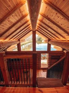 an inside view of a wooden cabin with a large window at Log Cabin/Hot Tub on Private Lake Jurassic Coast in Bridport