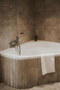 a bath tub with a faucet in a bathroom at Hadens Guesthouse in Nelspruit +75 photos
