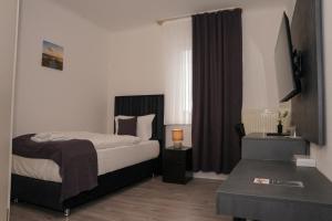 Postel nebo postele na pokoji v ubytování GN Hotel Furpach + 7 fotografií