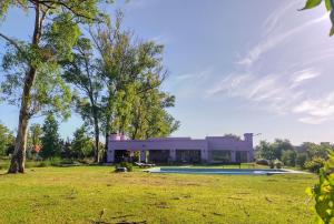 a house with a swimming pool in a field at La Asunción 114 in Luján