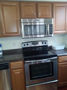 a kitchen with a stove and a microwave at One bedroom with free parking in Schenectady