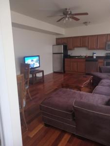 a living room with a couch and a kitchen at One bedroom with free parking in Schenectady