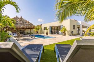 a villa with a swimming pool and a resort at Villa Mambo Royale in Willemstad