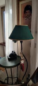 a lamp sitting on a table next to a picture of a child at Grand Rive in Saint-Pierre