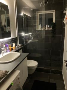 a bathroom with a sink and a toilet at Private room in a shared apartment with amazing view in Reykjavík